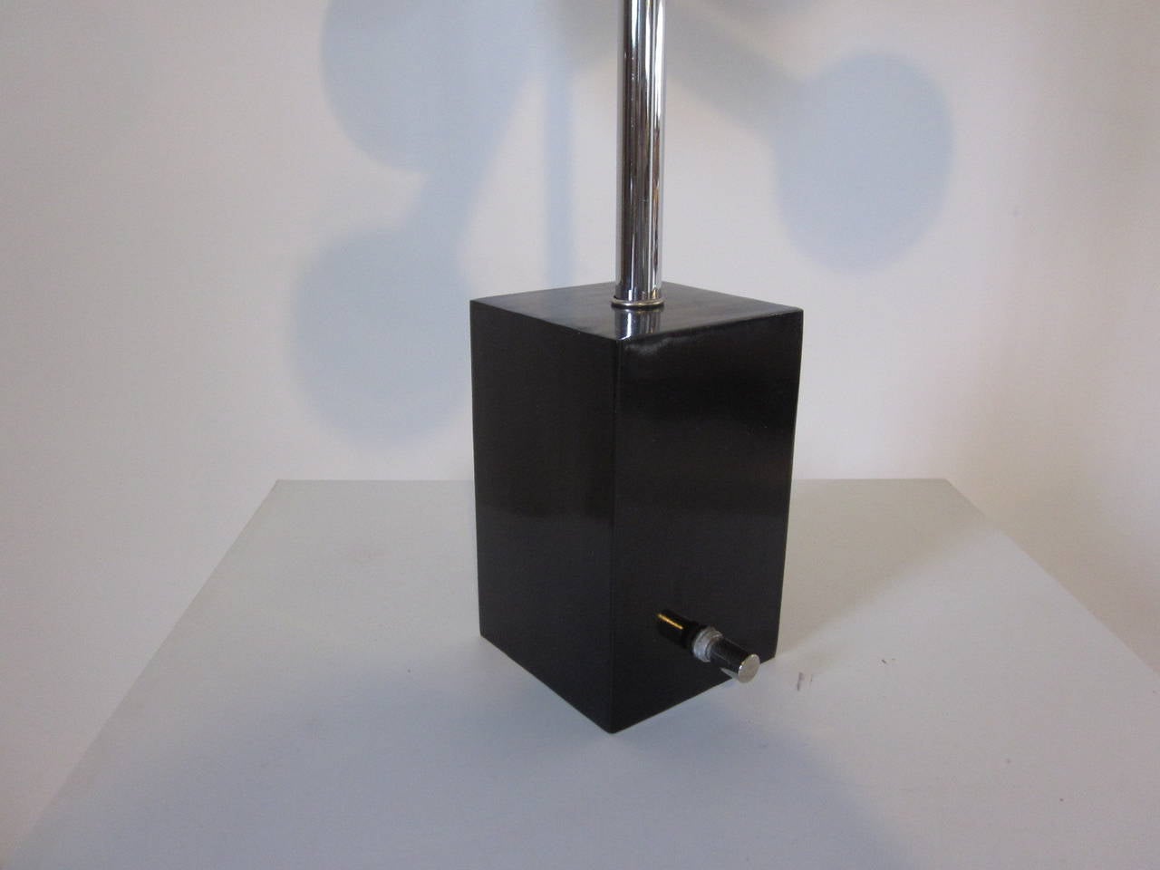 A chromed Sputnik table lamp with a Space Age look , six arms and large white bulbs mounted with a matching chrome rod on a black metal base with large chrome switch.