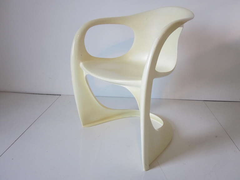 A molded organic ABS arm chair in off white, a simple but very sculptural piece made in Germany by Casala. 
