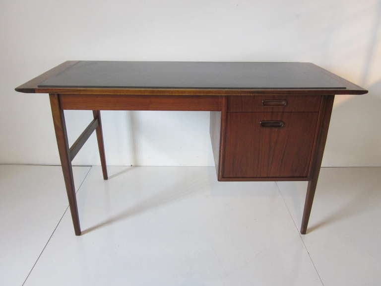 A Mid Century dark walnut two drawer desk with a inset gray / black slate top in the Danish style, in a tailored and rich look.