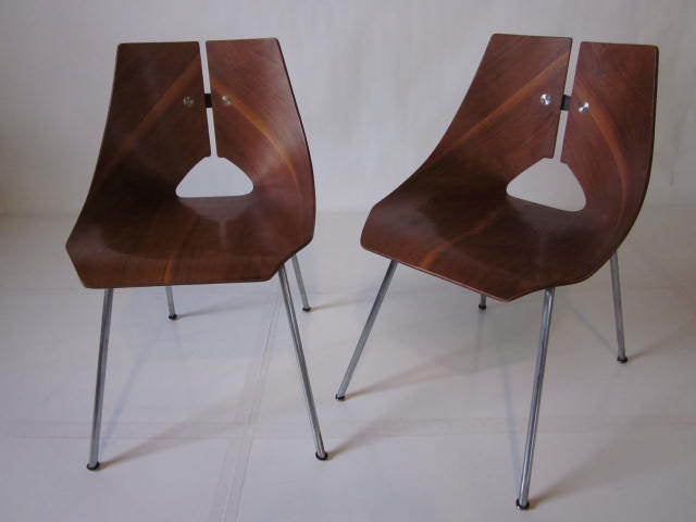 A pair of molded walnut plywood shell chairs designed by Ray Komai with satin chrome legs and metal back strap detail.Model number 939 manufactured by JG Furniture Co.