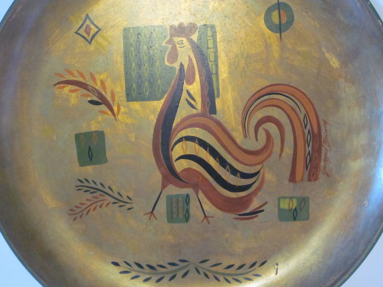 A Tolle styled hand-painted gold leaf toned large metal dished wall plaque with a rooster motif signed by George Briard with hanging hook to the reverse side.