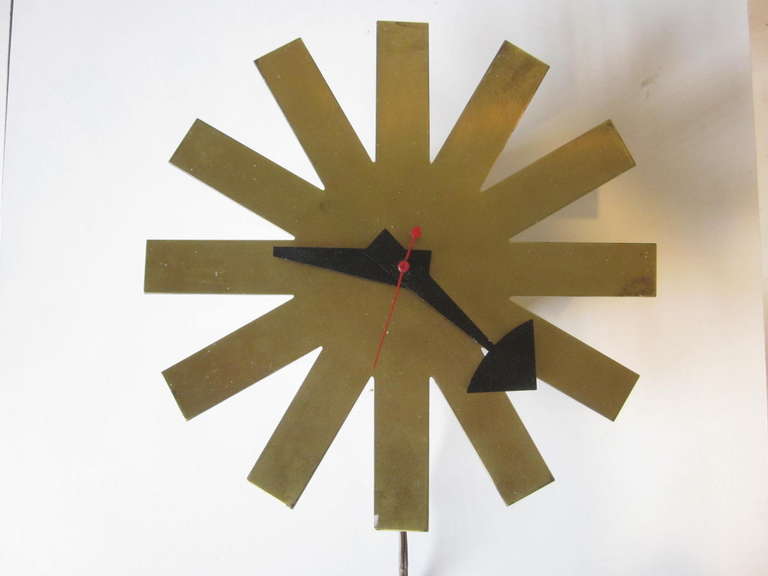 A hard to find version of the Nelson Asterisk clock with brushed brass finish and being a early production model having a wooden clock body. This electric model is in good working order and retains the manufactures decal from the Howard Miller Clock