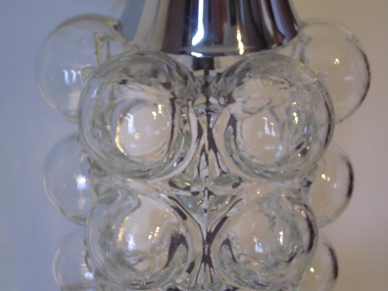 A handblown clear bubble glass table lamp with chromed base and linen shade in the manner of Helene Tynell.