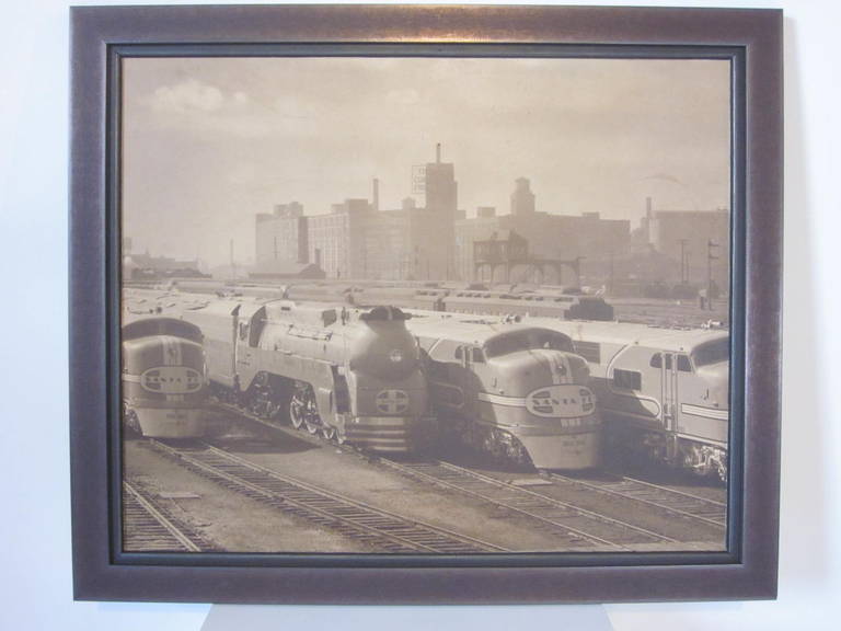 An original sepia toned photo showing the Chicago rail yard and four engines from the Santa Fe railroad, one being a Hudson engine in the streamliner style designed by leading industrial designers like  Raymond Loewy, Otto Kuhler and Henry Dreyfuss