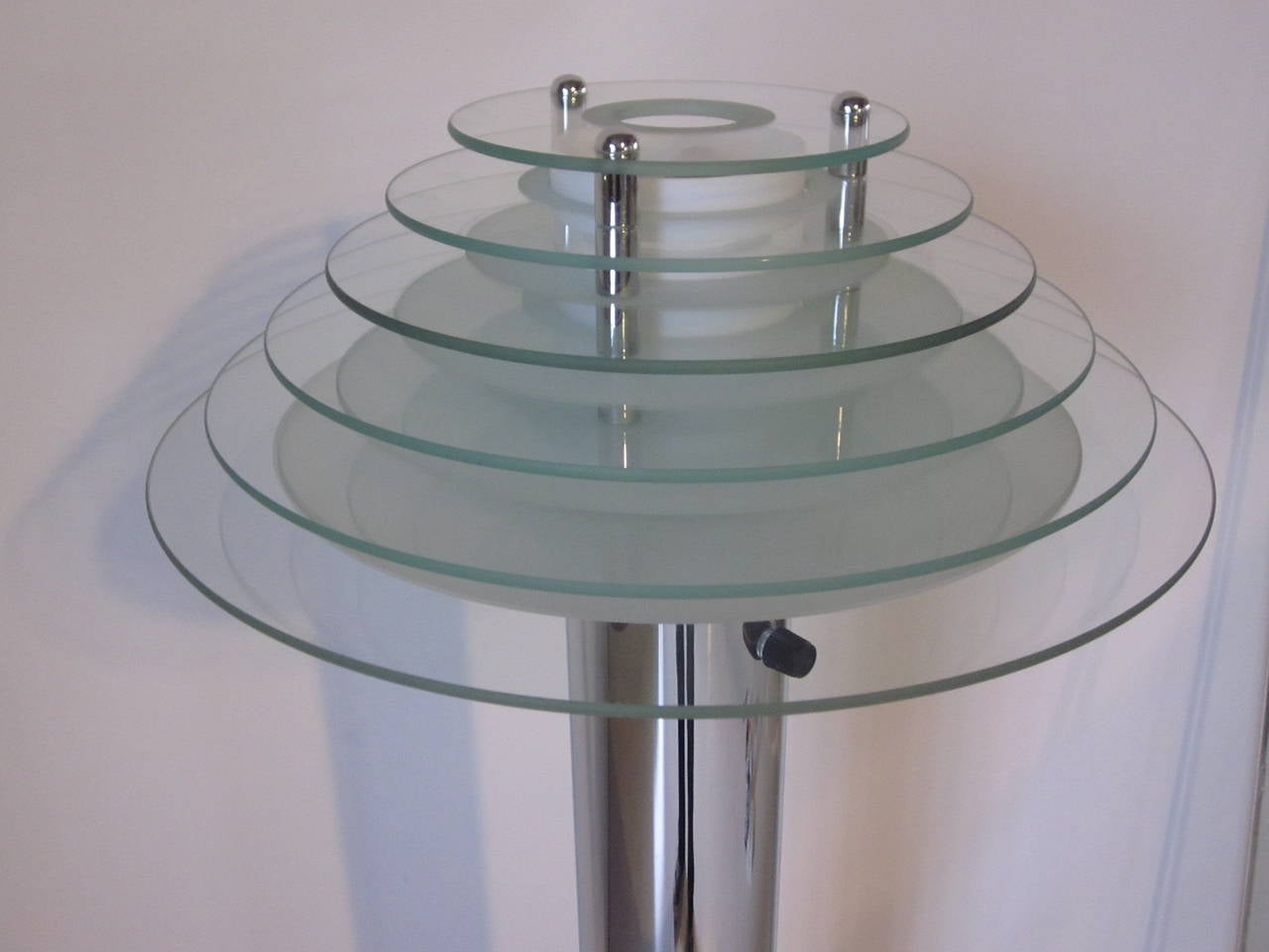 A chrome floor lamp with six graduated round clear and frosted glass plates for the shade and a internal white frosted glass defuser, large chrome pins separate the plates. Side dimmer and on and off switch to the side of the tube, made in Italy.