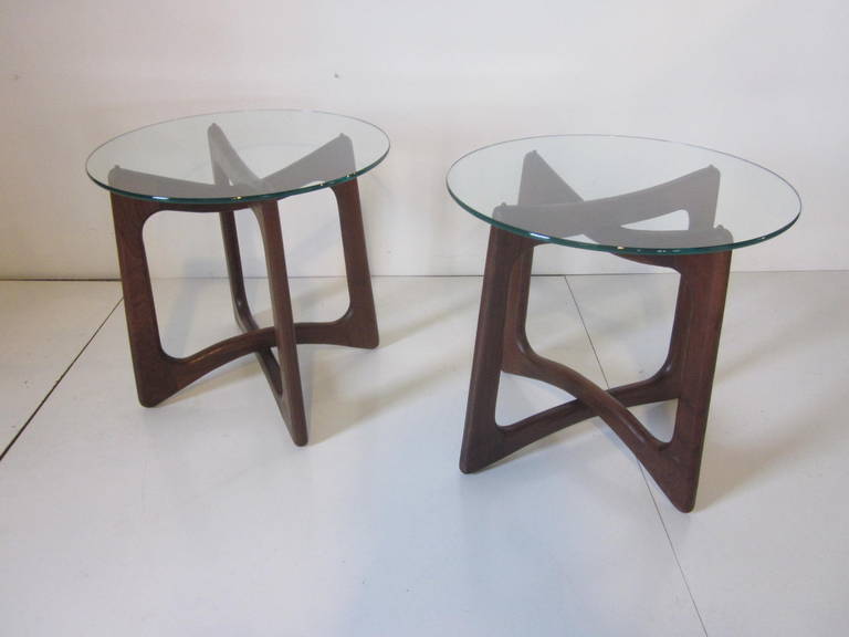 A pair of solid walnut and glass sculptural side tables manufactured by Craft Associates.