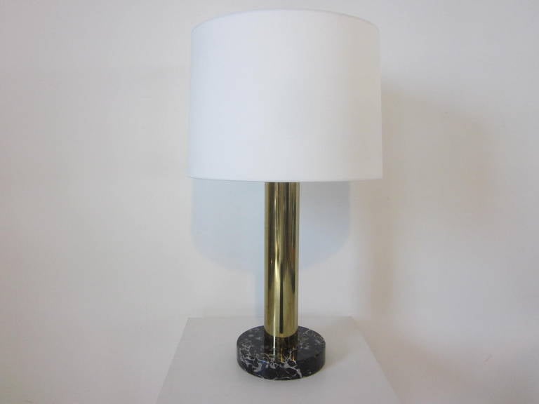 A brass and dark veined marble based table lamp with off-white linen shade manufactured by Nessen Lamp Company, NY .  Great for that home office or living space that needs some soft attractive lighting .