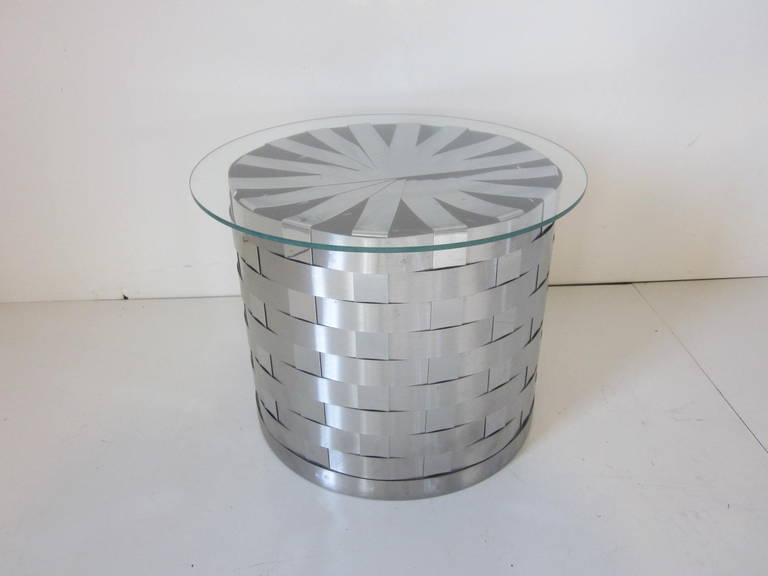 A woven stainless steel and glass side table with great asterisk top design.
