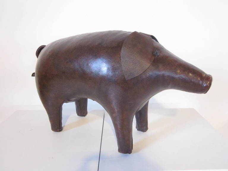 A wonderful hand stitched cowhide pig ottoman with big floppy ears and tail, made in England and imported by Abercrombie & Fitch company .