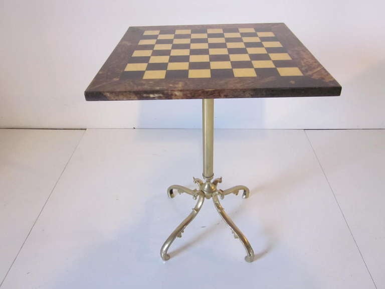 Aldo Tura goat skin chess table with cast gold toned metal base with cast goat heads and scrolled detailed legs. Retains designers tags and marked made in Italy.