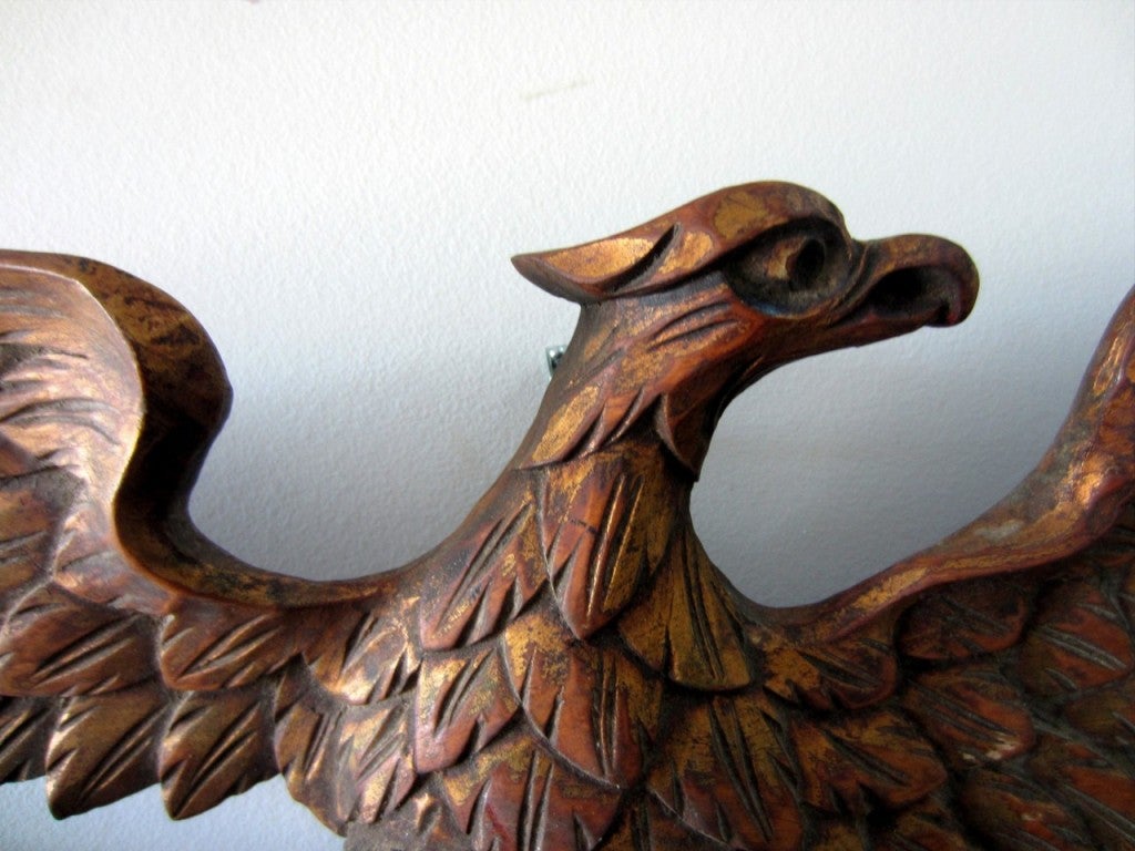 EXCELLENT GRAPHICALLY CARVED SPREAD WINGED EAGLE WITH SHIELD AND CROSSED, DRAPED FLAGS<br />
<br />
Original gilt and polychrome paint decorated pine carving, in wonderful condition and surface patina.  No breaks, damage or restoration.  Fine
