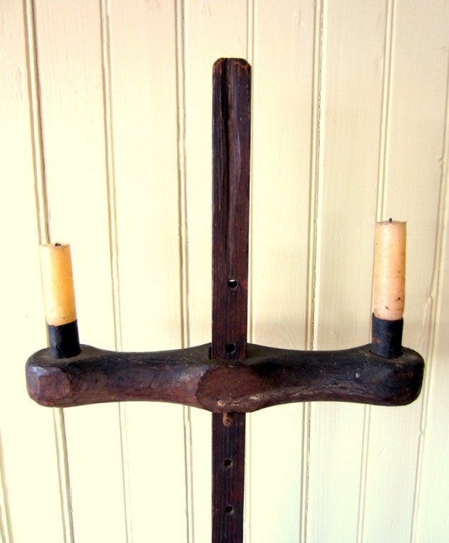 ANCIENT PRIMITIVE LIGHTING STAND<br />
<br />
Exceptionally rare, untouched original Pilgrim Century tripod base adjustable double socket lighting stand.  Wonderful survivor, with all original elements.  Massive rosehead nails secure the rear two