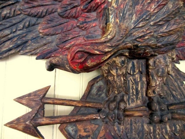 Excellent paint decorated finely carved eagle, shield, and crossed arrows wall plaque. Pine, with original red, white, blue and gilt paint decoration, exhibiting a pleasing, age darkened and mellowed overall patina. No breaks or repairs, in great