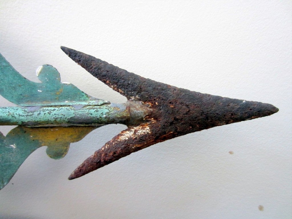 RARE, SMALL SIZE BANNERETTE WEATHERVANE <br />
<br />
Scrolled copper banner, iron arrowhead, and tall, delicate copper spire.  Vestiges of early white, gilt, and yellow paint, revealing excellent early verdigris surfaces.  Minor early solder