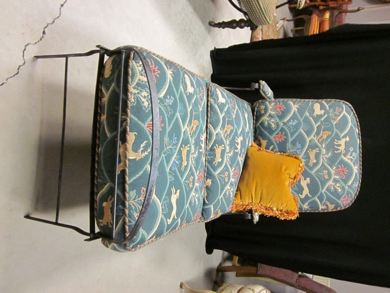 Late 19th century metal campaign bed. Custom cushions have been upholstered in designer fabric.   Can be folded and used as a chaise  with upholstered arm rests or fully extended and used as a bed. Full length is 72 inches. Metal and turned wood