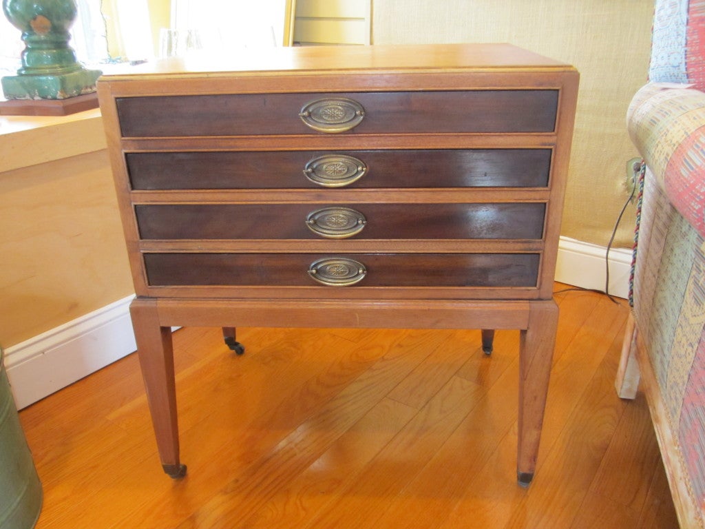 Rolling side table that stores four folding snack tables.  Mahogany with original hardware.