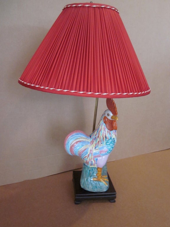 Tall colorful ceramic rooster statue made into a lamp.  Wood pedestal base with custom shirred red silk shade.<br />
Rooster height alone --16