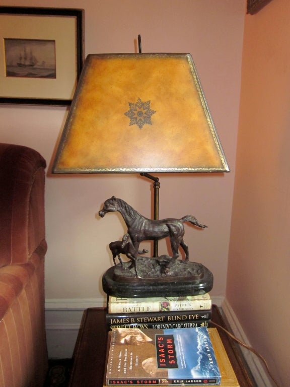 Pair of handsome bronze lamps with mother and foal.  Black marble bases and tooled leather shades.