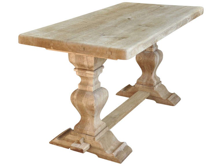 French farm table in washed oak. This beautiful piece would be perfect used as a dining table or desk. It is sure to bring lots of Provencal charm to your home!