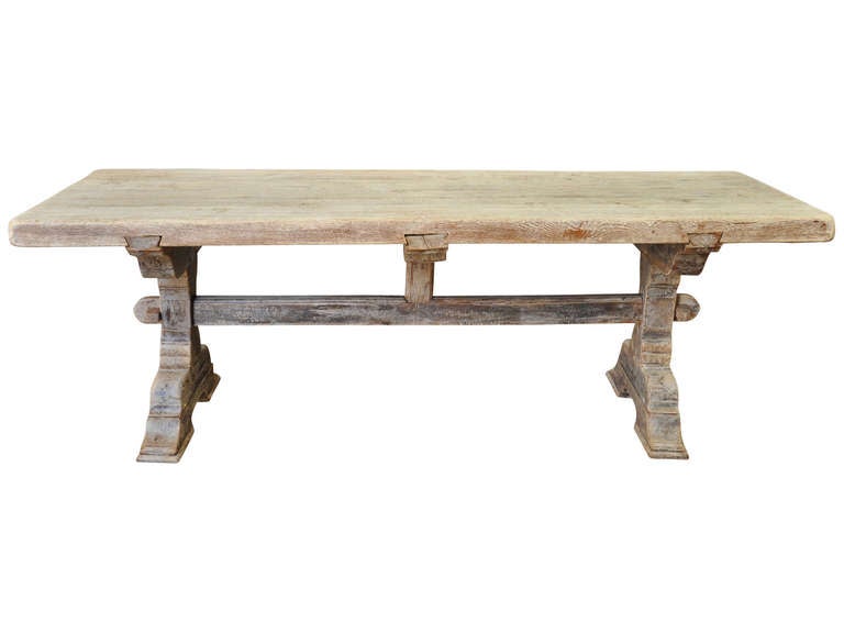 French antique trestle table in washed oak from the late 19th, early 20th century. This table comes from the Southwest of France and is a very versatile piece. Use it as a dining table, kitchen table, or even as a desk for a home office.