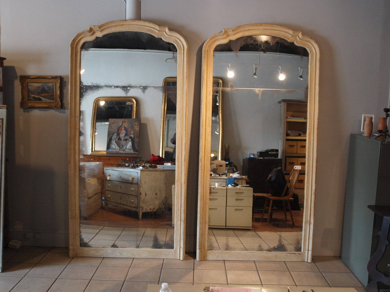 A stunning pair of early 19th century grand scale architectural door frames as trumeau style mirrors. These fantastic mirrors retain their original paint. The paint is in a very soft shade of pale, pale yellow with vanilla undertones. The price for