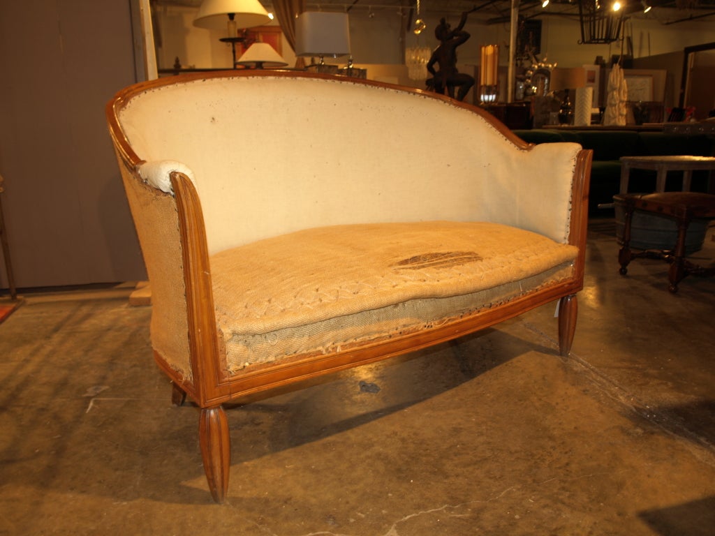 1920's Style French Banquette in Walnut. This beautiful piece has a great curved back and high arms. It would look lovely in a sitting room. Paired with a round table it would make a great design statement instead of the traditional dining room