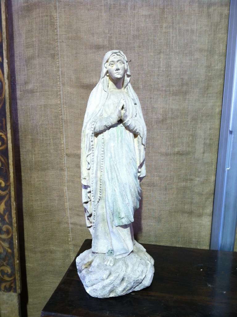 Antique Spanish Madonna statue, circa mid 19th century. This beautiful limestone statue is carved from one block of stone. It is the perfect decorative object for your home or garden. The Madonna has a tranquil face and an overall sense of serenity