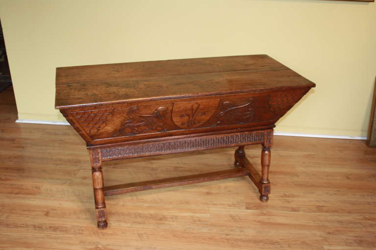 A stunning 18th century Petrin from France's Loire Valley region. This Dough Table is constructed from walnut and is in 3 sections - the base, the trough and the top. The Petrin is beautifully carved on the front and the two sides.  By the use of a