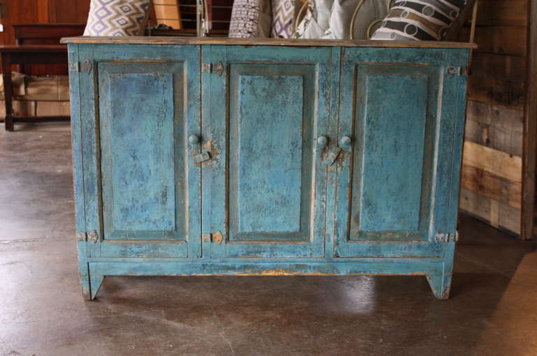 Mid 19th century antique buffet from Portugal in painted wood. This beautiful piece has a lovely painted finish that is sure to add character to any room it graces. The scale makes it very versatile. You can use this as a buffet in a small dining