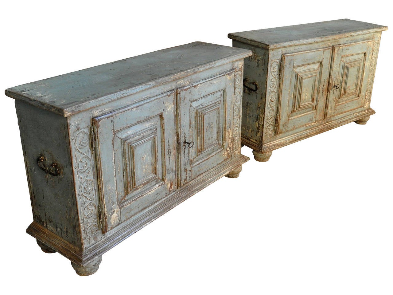 An outstanding pair of 17th century painted buffet from the Catalan region of Spain.  Nice carved detailing along with substantially molded door panels, iron handles to the sides resting on large bun feet.  These cabinets are in wonderfully sound