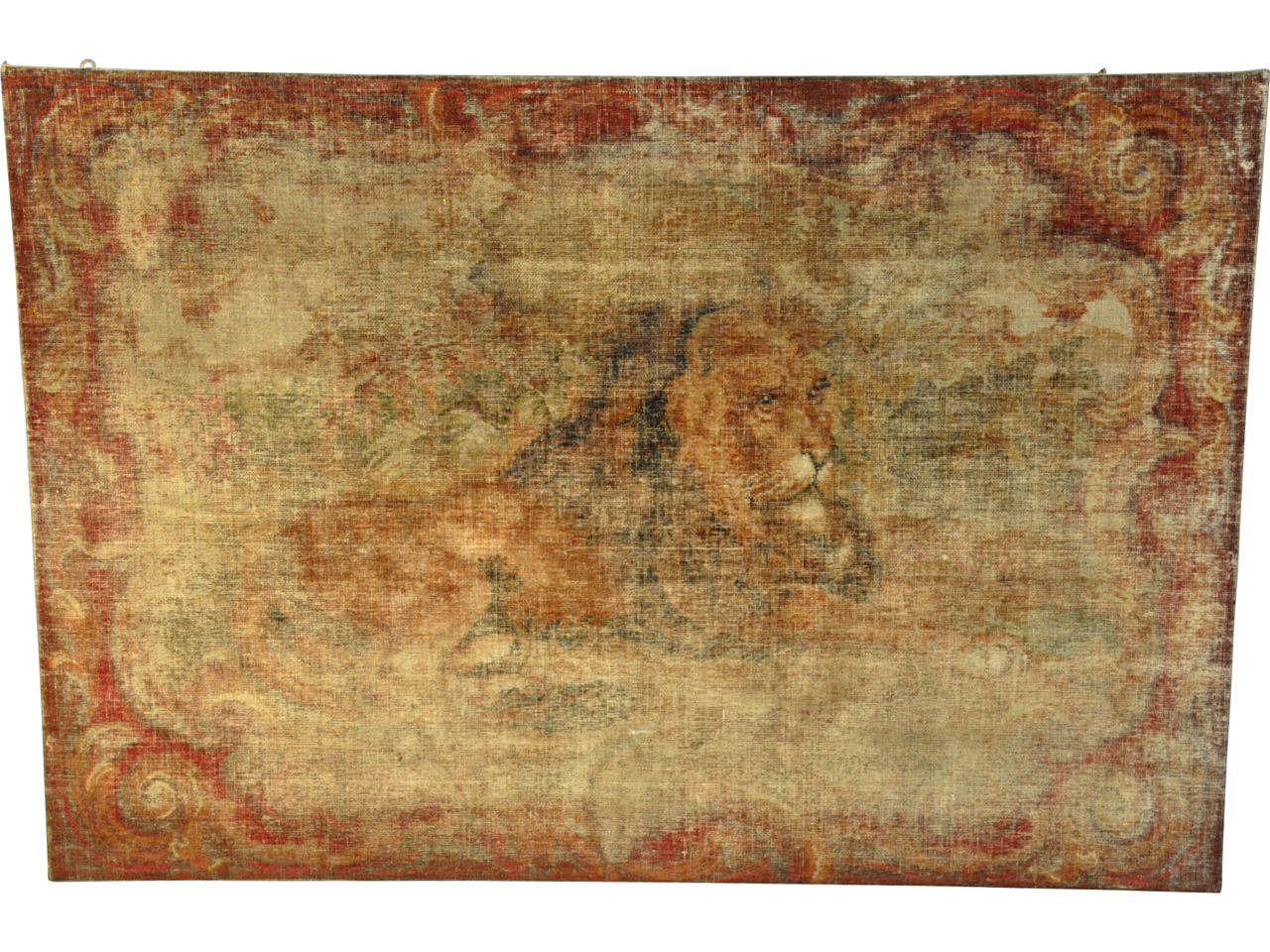 A stunning 18th century Italian needlepoint of a recumbent lion. This magnificent piece is stretched on a wooden frame with a finished side border. The palette is subdued in rich hues of sienna and ochre. This majestic lion has a proud and peaceful