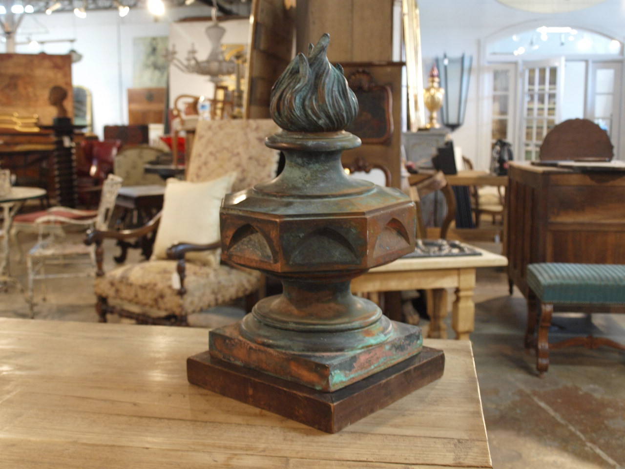 A beautiful 19th century French architectural flame finial salvaged from a building in central France. The finial now rests on its antique wooden base. The finial is beautifully constructed and the copper has a very rich patina. The flame finial is