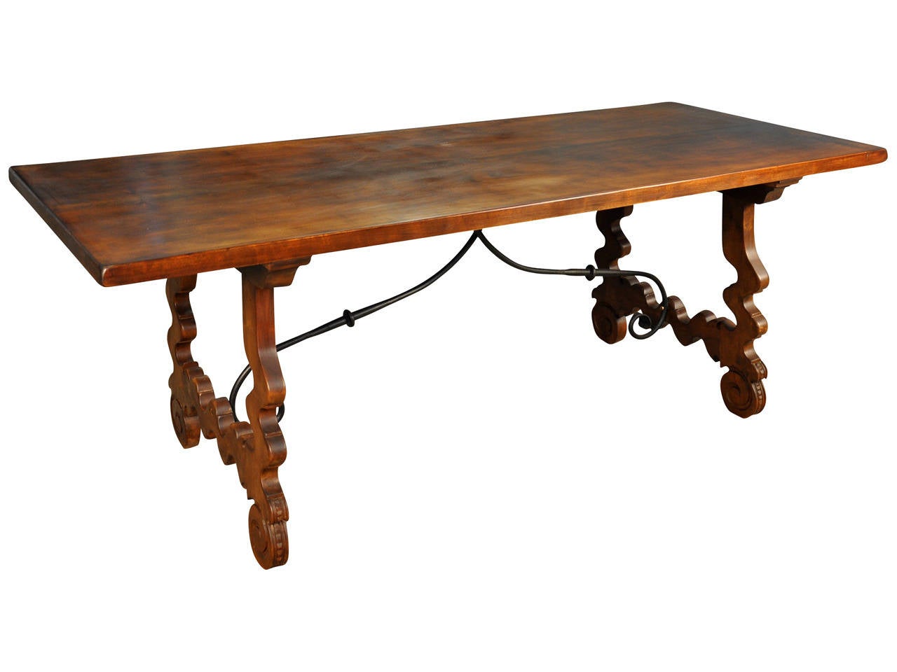 A very handsome early 20th century Spanish Farm Table constructed from walnut and iron trestles.  This striking table not only serves as a wonderful dining or breakfast table - but can be used beautifully as a writing desk or sofa table as well.