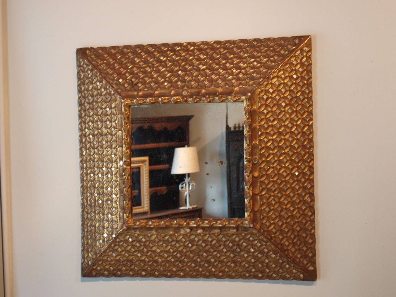 An outstanding later 19th century Spanish Colonial mirror in giltwood.  This mirror is intricately carved and has several hundred hand cut mirror pieces inlaid into the frame.  The gilt is of high quality - worn with time to show traces of the brick