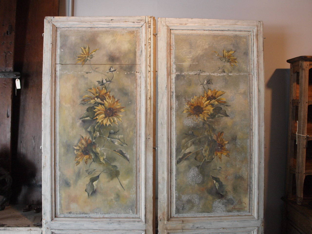 A beautiful pair of French painted door panels.  The artwork is of sunflowers and is signed by C. Klein and dated 1903.  Wonderful as art work or incorporated as pantry doors or other architectural elements.