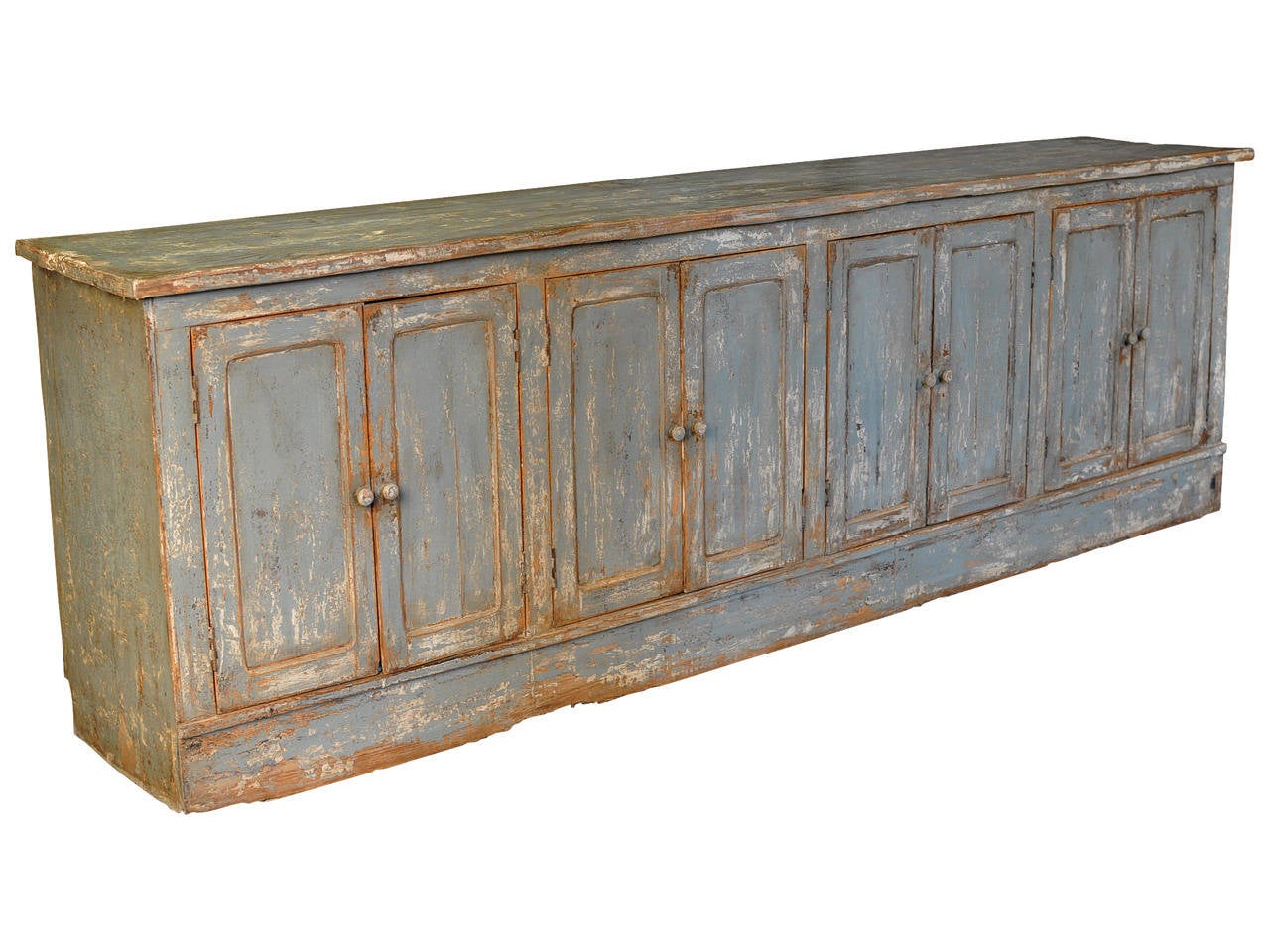 A charming mid 19th century Portuguese painted store counter enfilade.  This wonderful piece is finished on all sides.  An excellent storage piece with four double doors and interior shelving.  This long enfilade can be used as a buffet, an island