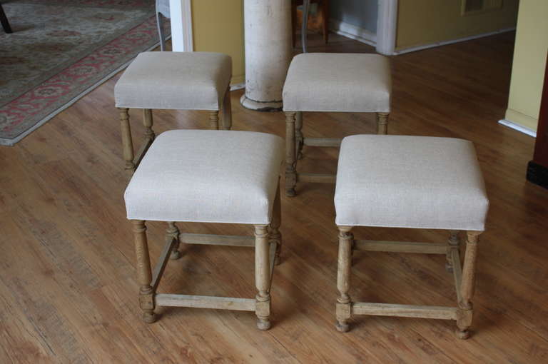A charming set of four Louis XIII style stools in washed oak from France.  These early 20th century stools are very versatile.  Great as additional setting.  One can also place a small plateau on top and use as a cocktail table or occasional table. 
