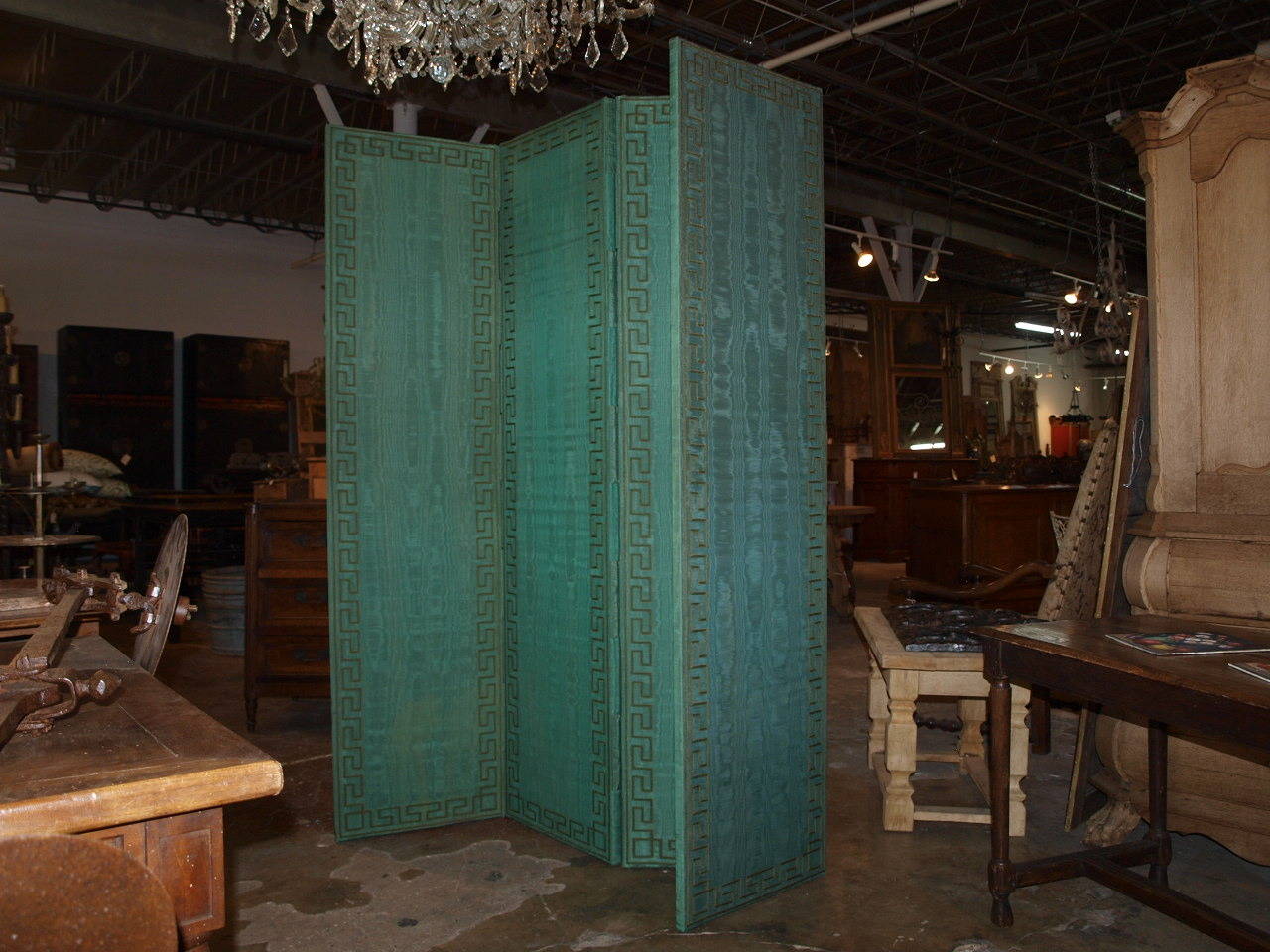 A striking French Art Deco Period Paravant - or standing screen in a sumptuous emerald green silk.  The panels are bordered with a handsome Greek key pattern.  Both sides of the screen are finished so that it may serve as a room divider.  This