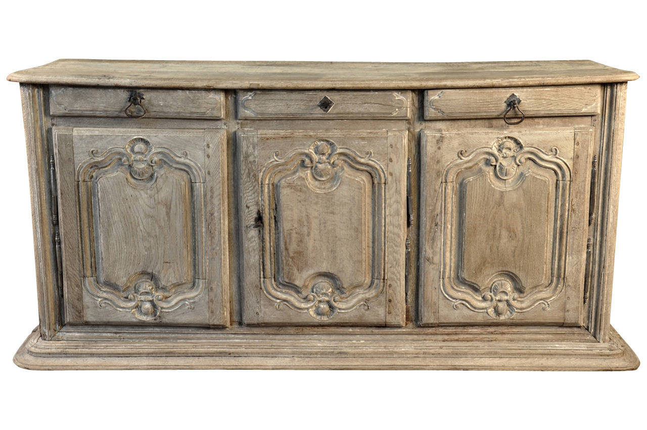 A stunning 18th century French Louis XIVth style Enfilade - Buffet in bleached oak.  Beautifully constructed with a substantially molded base, three molded door fronts and three drawers.