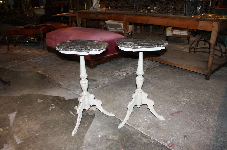 A charming pair of 19th century painted Swedish Cocktail Tables - Side Tables with their original marble tops.  The marble tops have a warm patina and are removable.  The marble is black in color with a white vein.  The wood is painted in a very