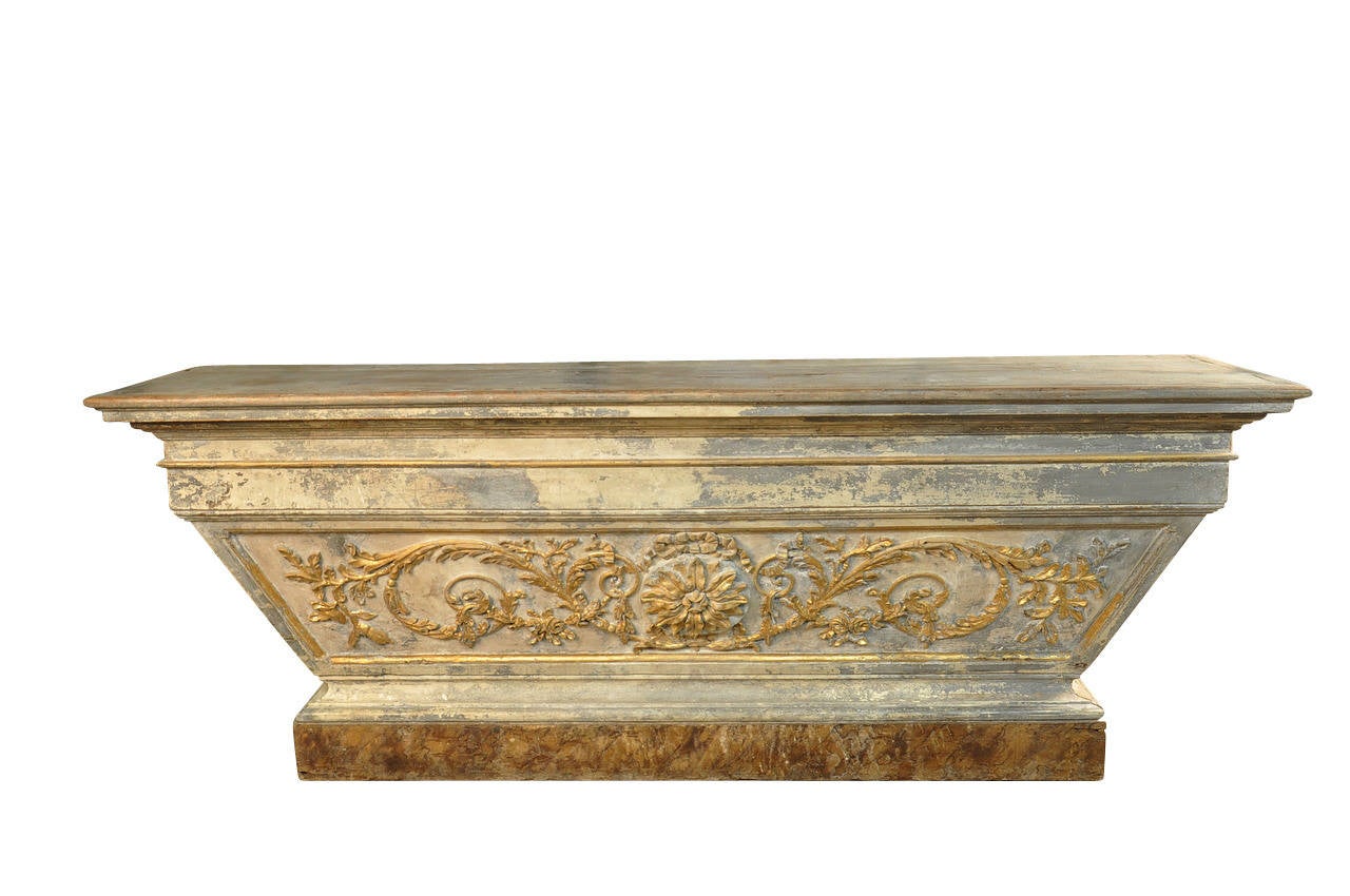 A stunning Spanish 18th century altar console in painted and giltwood. The soft painted finish in hues of soft grey blue and off-white is wonderfully accented with the gold gilt decorations and with the faux marble base.