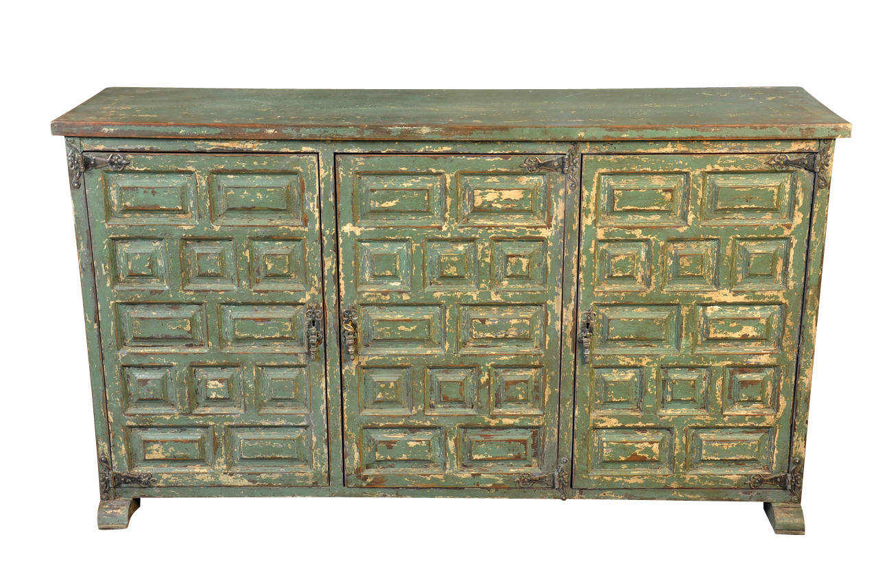 A charming Portuguese colonial early 19th century buffet in painted wood. The painted finish is in a rich emerald green. The hinges and door pulls lend added charm.  A fabulous accent piece with wonderful narrow depth.  This piece will add character