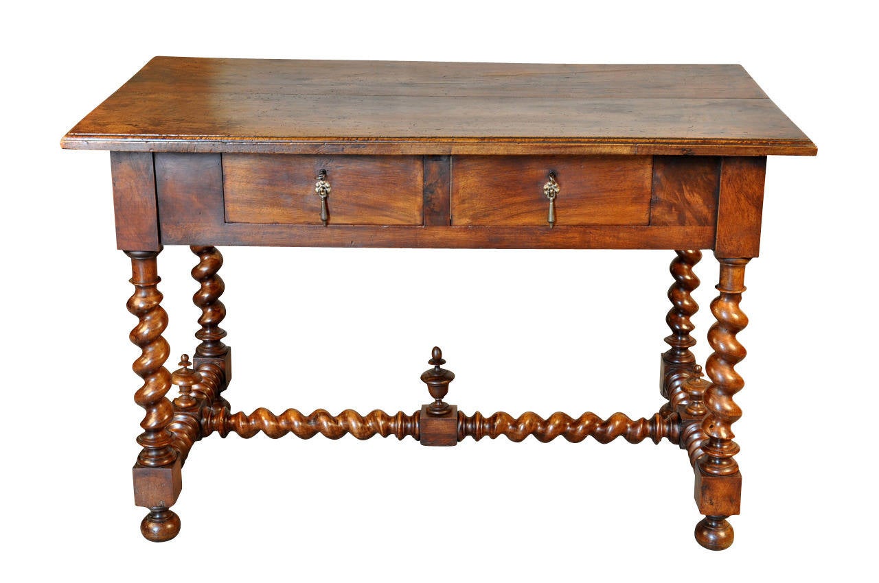 A lovely 19th century French Louis XIII style desk or writing table.  Wonderfully constructed from solid walnut with two drawers and nicely turned legs.  Lovely patina.