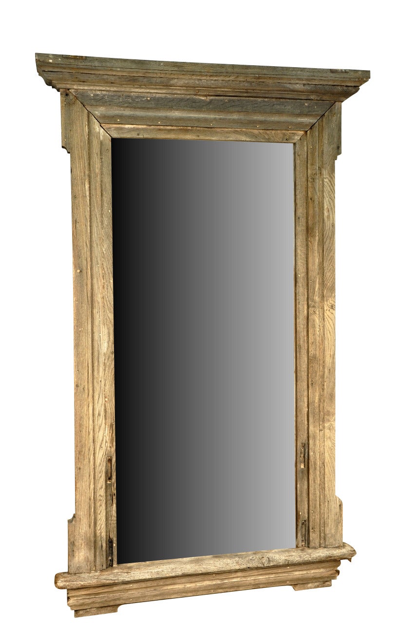 A monumental pair of French window frames in naturally washed wood now as mirrors. Beautifully constructed with heavy molded frame members. Wonderful accent pieces for high ceiling rooms.  In most of the photos, the mirror has been photo shopped....