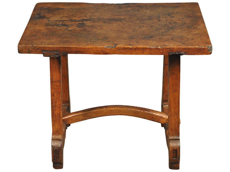 A very charming Spanish early 18th century primitive side table constructed from walnut.  The top of this wonderful table is single board.  Wonderful not only as a side table, but this piece would serve very well as a bedside table or cocktail table.
