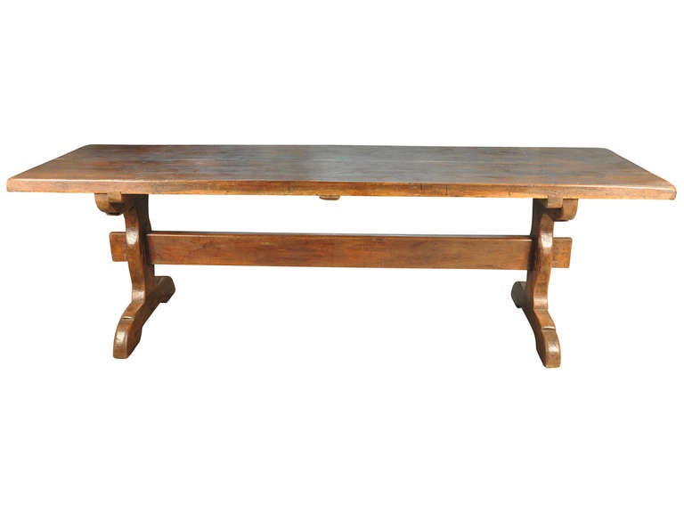 A very handsome early 19th century French Farm or Trestle Table in stained oak.  This table has a rich and luminous patina.  Not only does this piece serve as a wonderful dining table, but as a large desk or conference table as well.