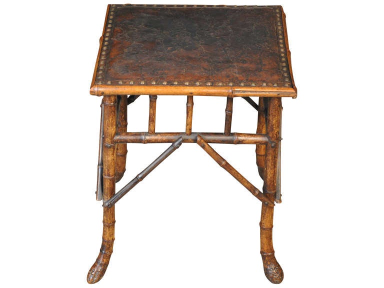 A delightful French stool, cocktail table in Bamboo and Leather.  The leather surface is beautifully embossed in a charming floral motif.