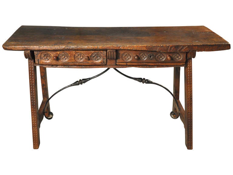 A lovely late 18th century two drawer trestle console constructed in walnut and hand forged iron trestles.  The top of this wonderful piece is a solid board with luminous patina and striking grain patterns.  This console would also serve as an