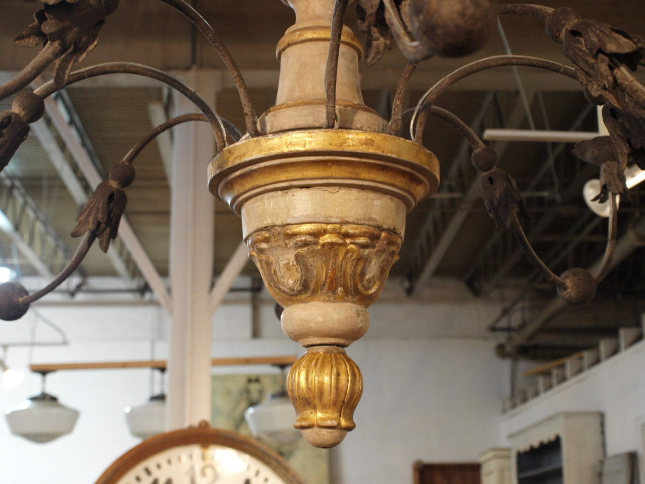 A very lovely 18th century eight-light chandelier from Northern Italy. This beautiful chandelier is made from lacquered and gilt carved wood with elegantly forged iron arms. The elegant simplicity gives this chandelier a very light and refreshing