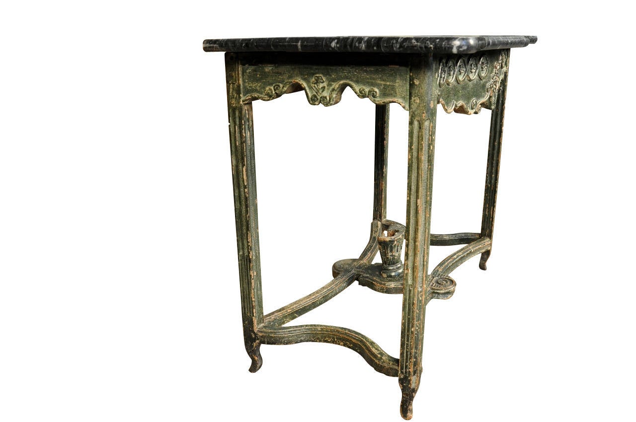 A delightful 18th century painted wood console from Portugal.  The painted finish is in sumptuous tones of rich greens.  The carving enhances the piece's charm.  A wonderful piece that be used as an entryway piece, an end or side table or as a